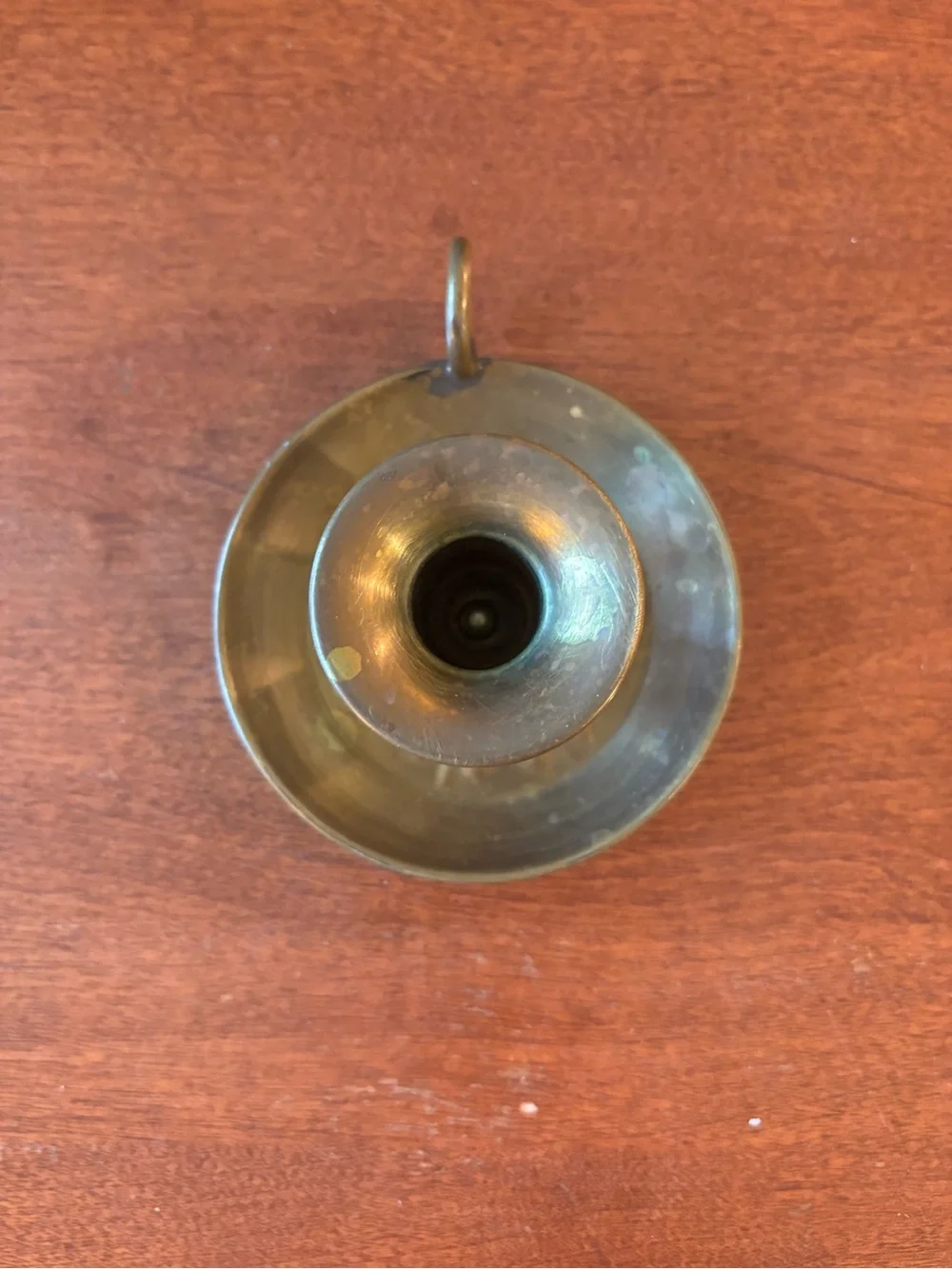 vintage brass chamberstick candle holder with a circular base and a ring handle
